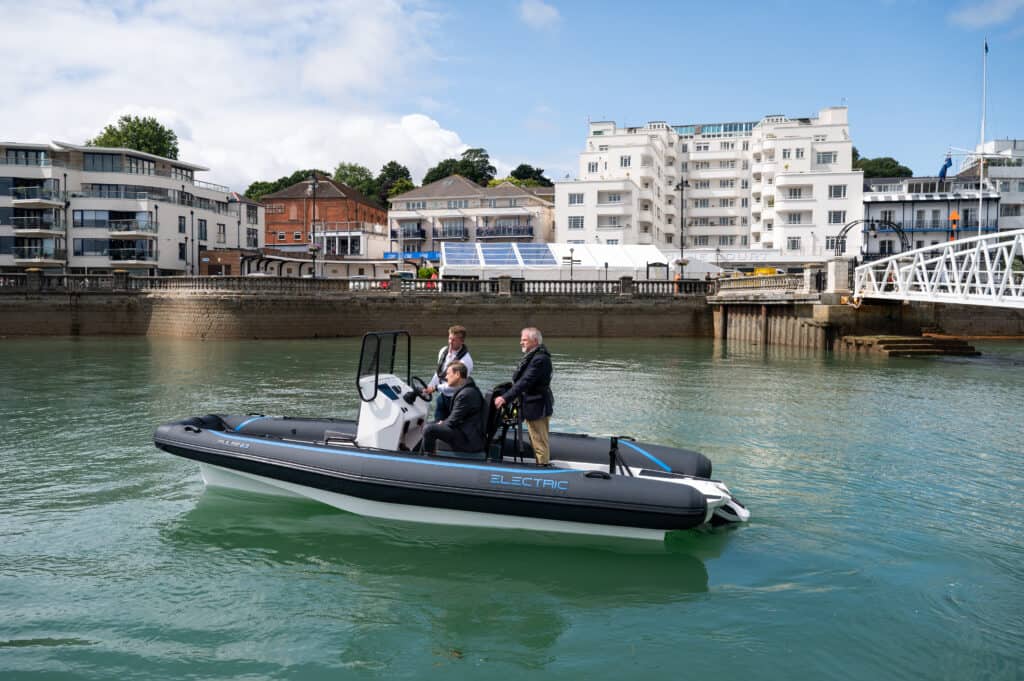 MP Bob Seely and Cowes Harbour CEO Gary Hall head on on a black electric RiB to experience the technology on the water.